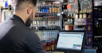 liquor store owner using a pos system