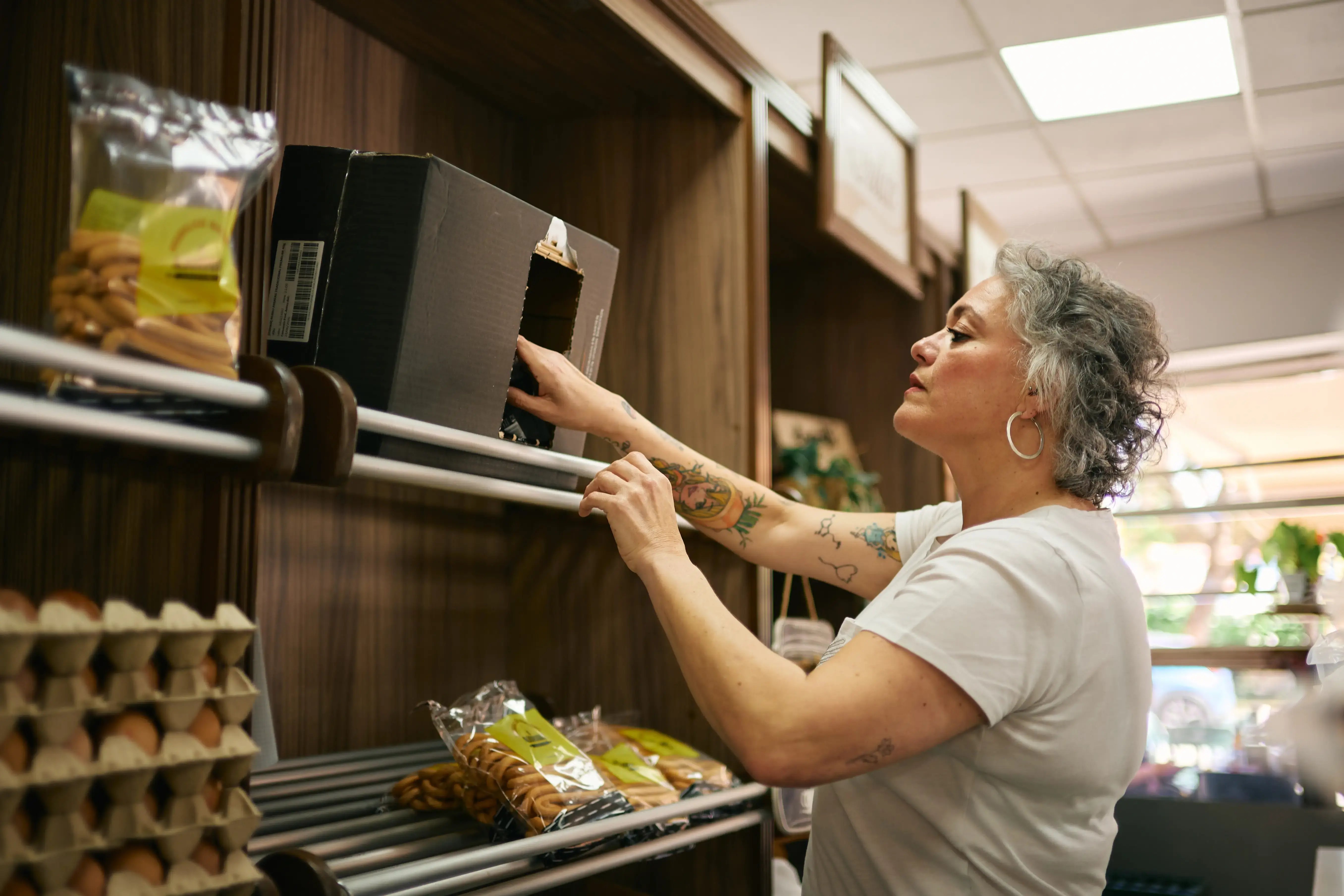 Grocery store employee shelving inventory