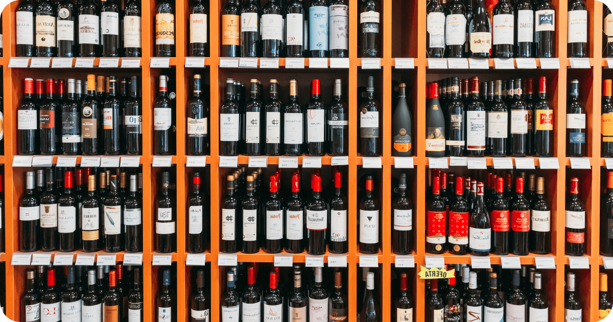 wine bottles on liquor store shelf priced by tier